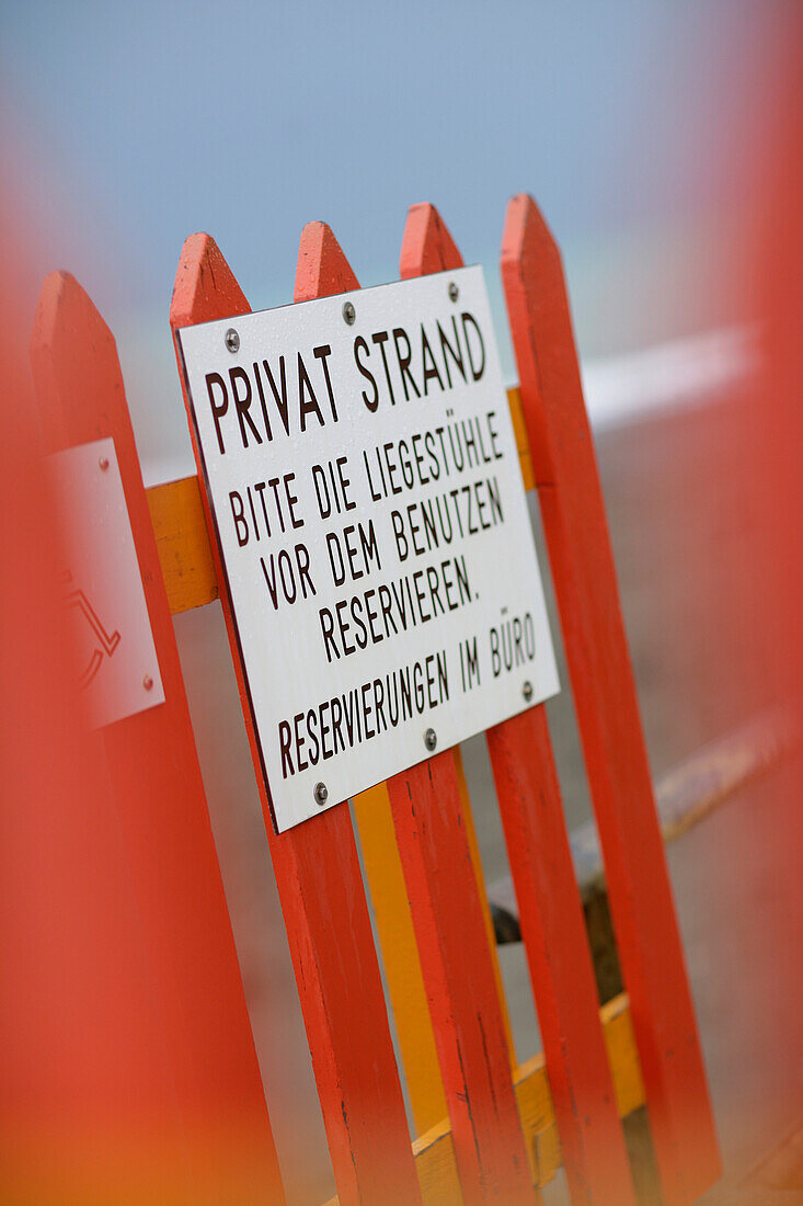 Sign on a fence of a private beach, North Sea, Germany