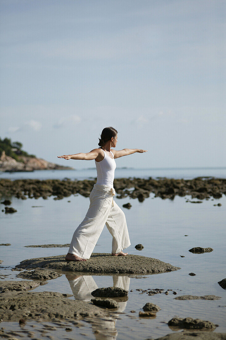 Woman doing Yoga exercises on the beach, Wellness, Relaxation, Health, Thailand