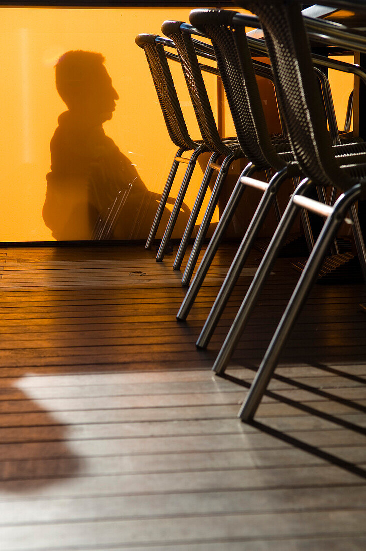 Shadow of a person in a bar on wall, Barcelona, Spain