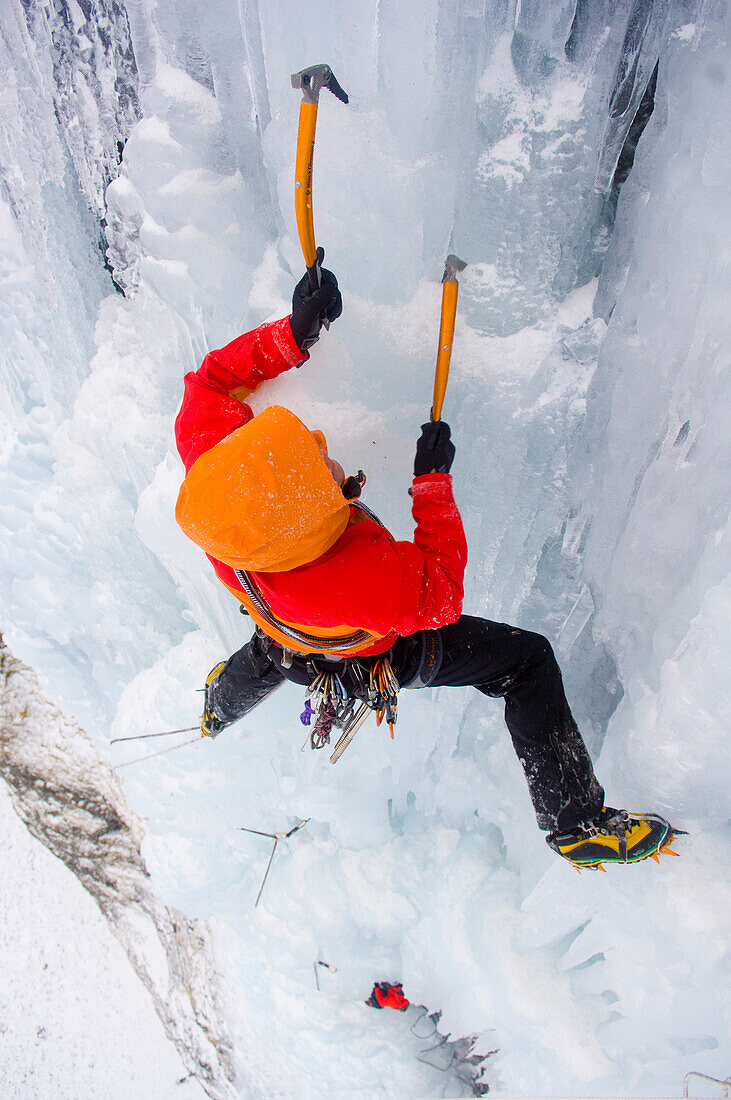 Ice climber in frozen waterfall, Kaldakinn, Iceland