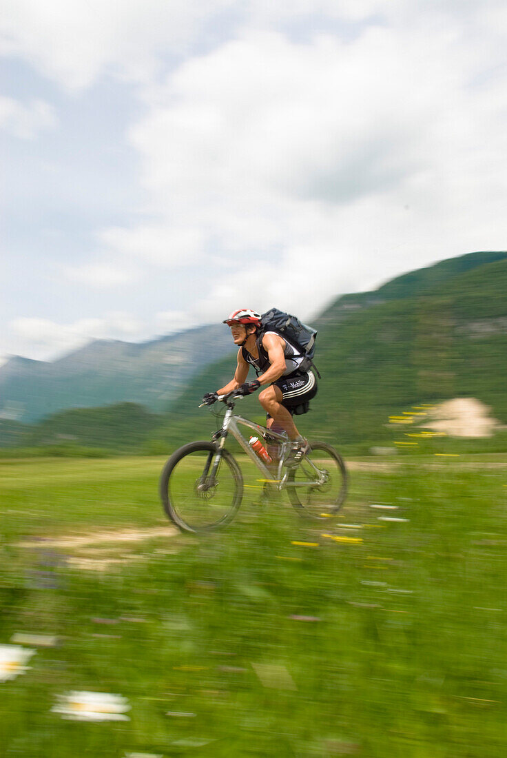 Mountainbiker on meadow, Slovenia