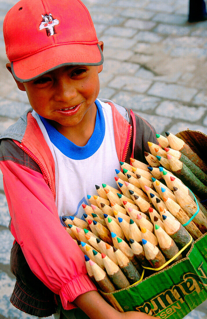 Kid selling crayons in the streets. Quito. Ecuador