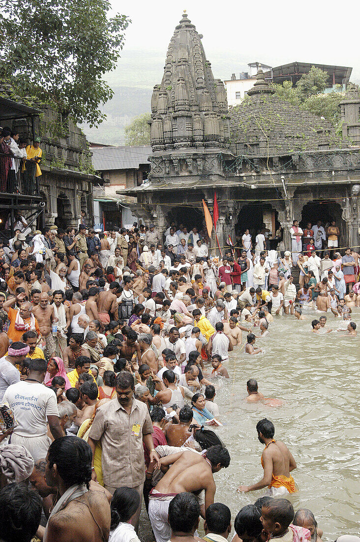 Devotees taking holy dip during the Kumbh Mela (2003). Trimbakeshwar, near Nasik. Maharashtra. India