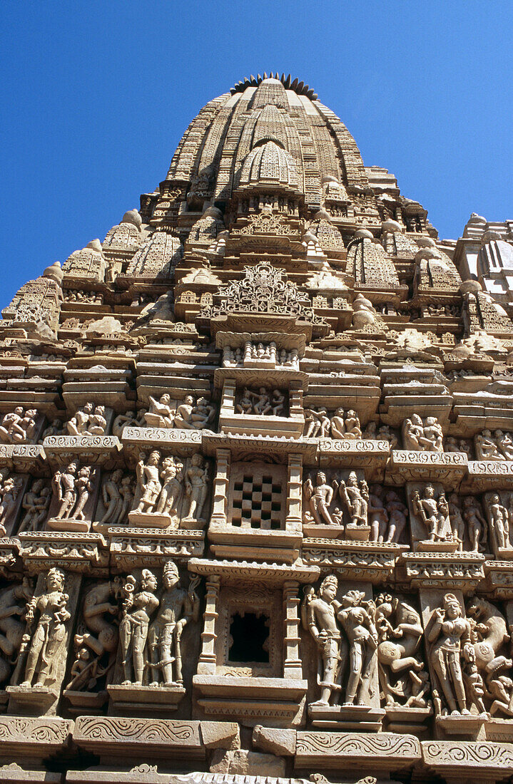 Ornate sculptures in three tiers around Paraswanath Temple, Khajuraho. Madhya Pradesh, India