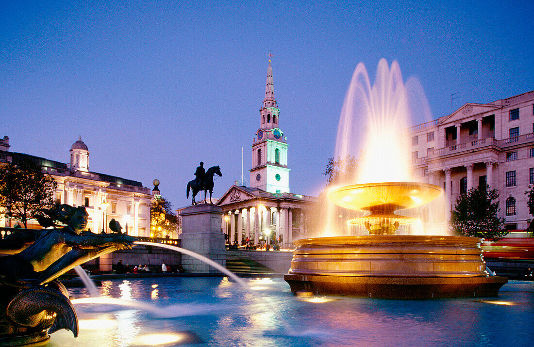 Fountain at Trafalgar Square, Saint Martin in the Fields church in background. London.