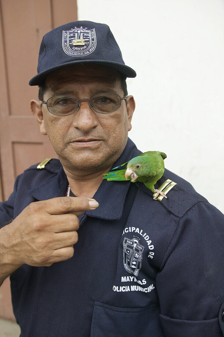 Municipal Police with pet bird on shoulder. Iquitos. Peru