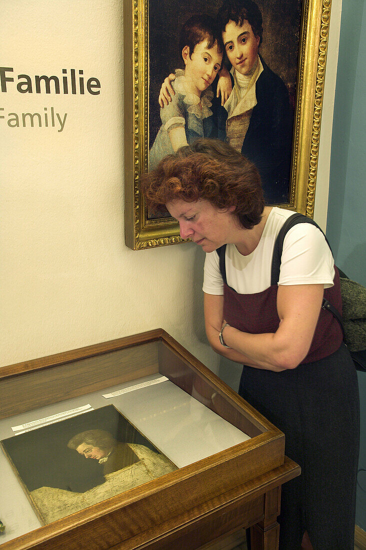 Woman looking at Joseph Lange s unfinished portrait of Mozart. Birth house of Mozart. Salzburg. Austria