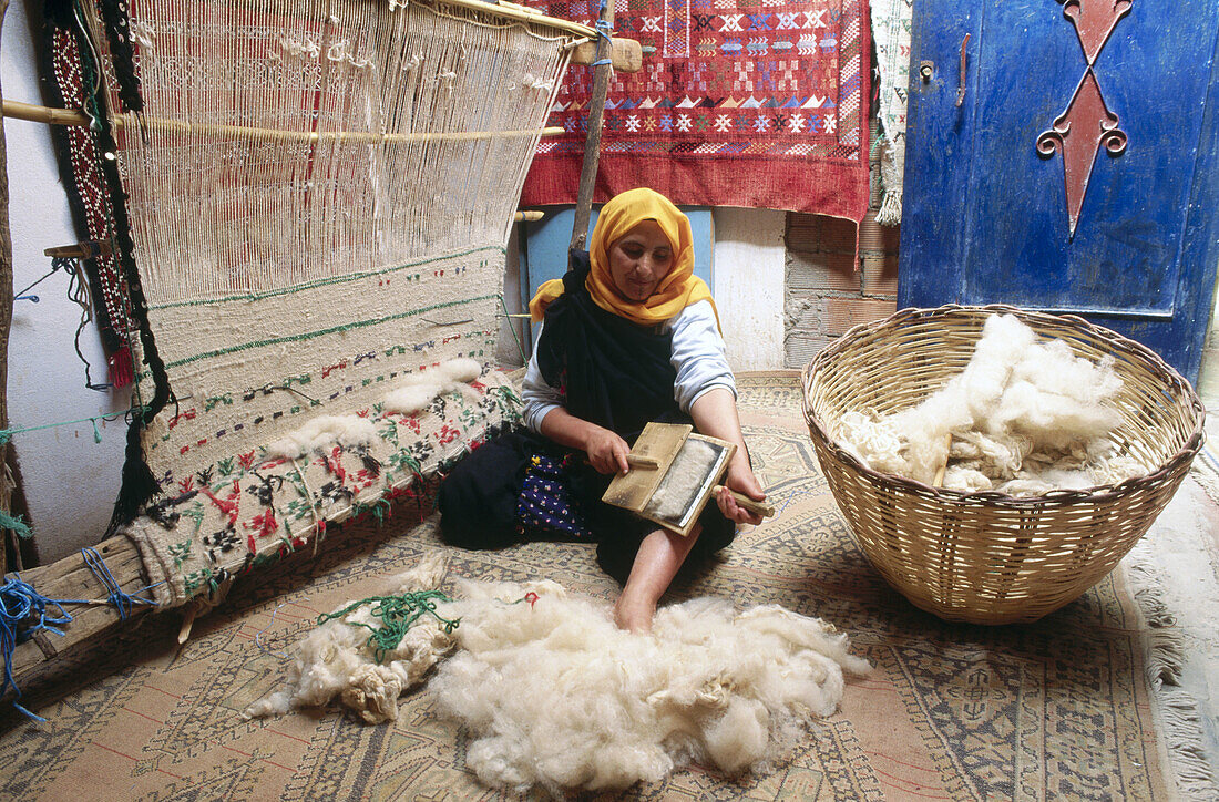 Woman weaving carpet. Tinerhir. Todra valley. South Morocco.