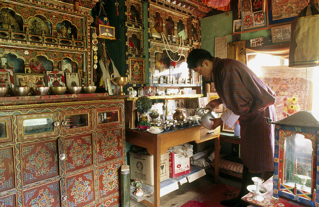 Praying and daily offerings inside a house. Thimpu, Bhutan
