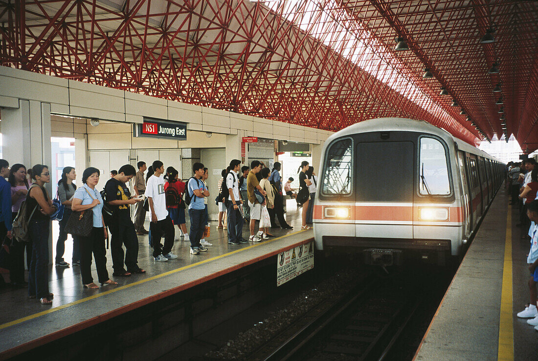 Mass rapid transit train arriving at interchange station. Singapore