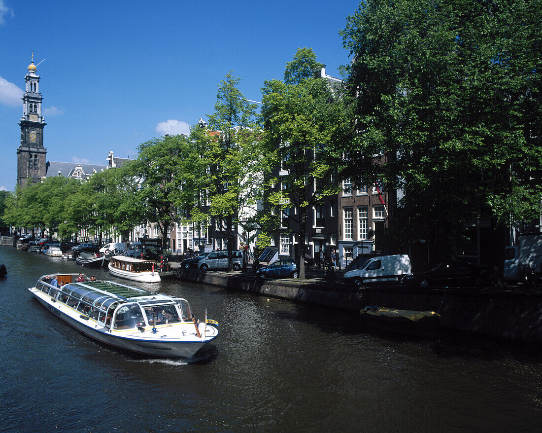 Pleasure boats on an Amsterdam canal. Amsterdam. Holland