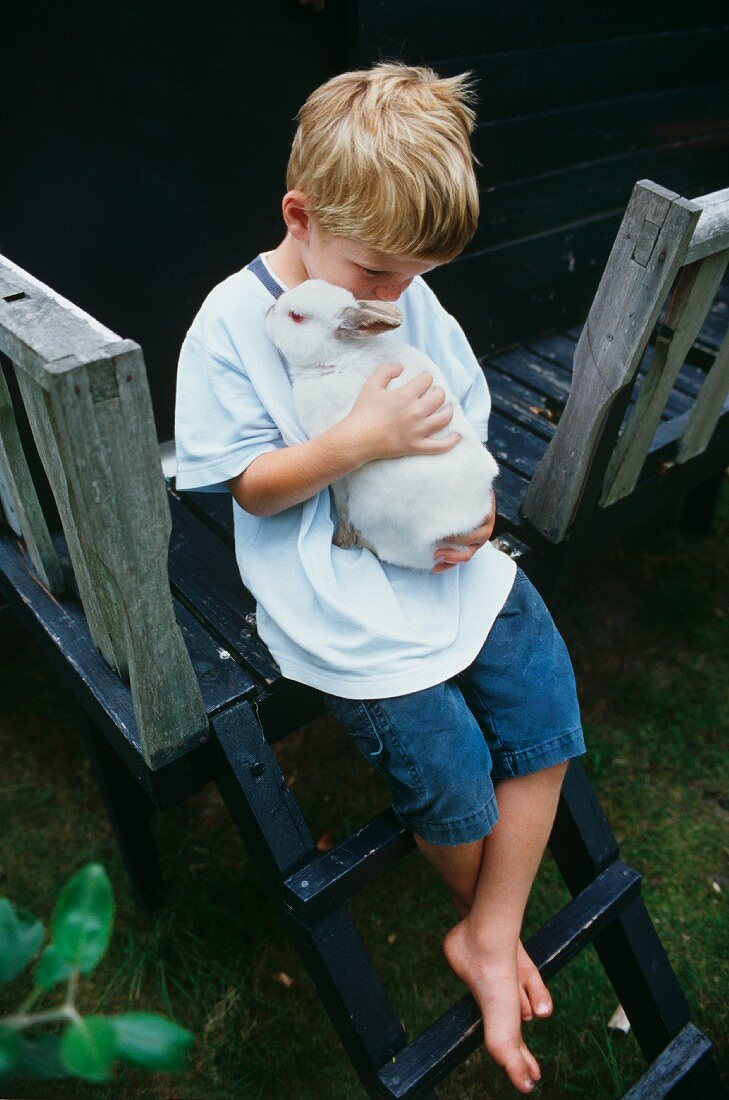 A boy with a white rabbit