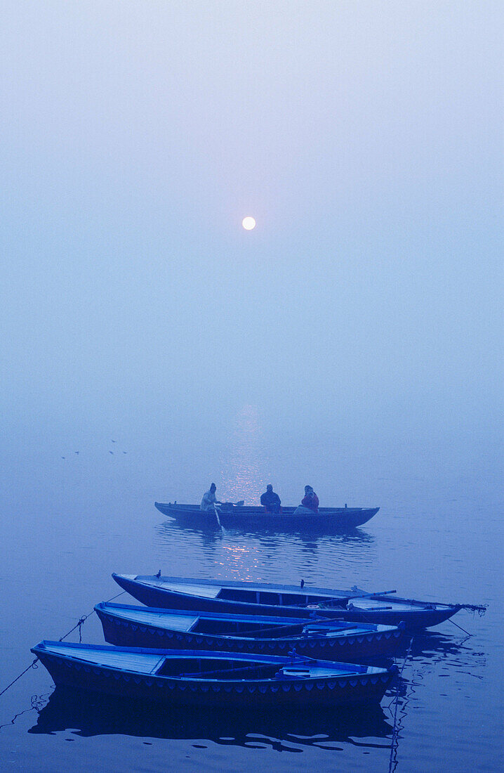 Sunrise with boats in River Ganga. Varanasi. Uttar Pradesh. India.