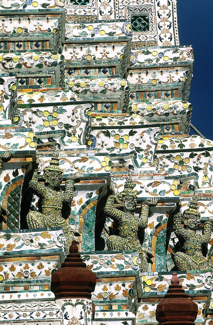 Close up on the tower plated with mosaic of porcelain pieces. Wat Arun temple (Temple of the Dawn). Bangkok. Thailand