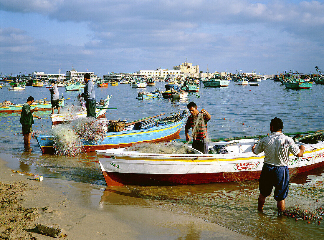 Fishing boats anchored at bay with Qait Bay fortress at rear. Alexandria. Egypt
