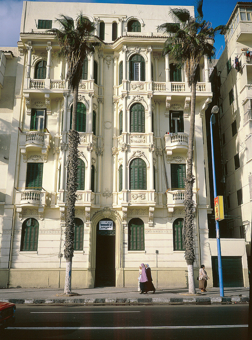 Old 1900 style housing buildings and palm trees at Corniche area. Alexandria. Egypt