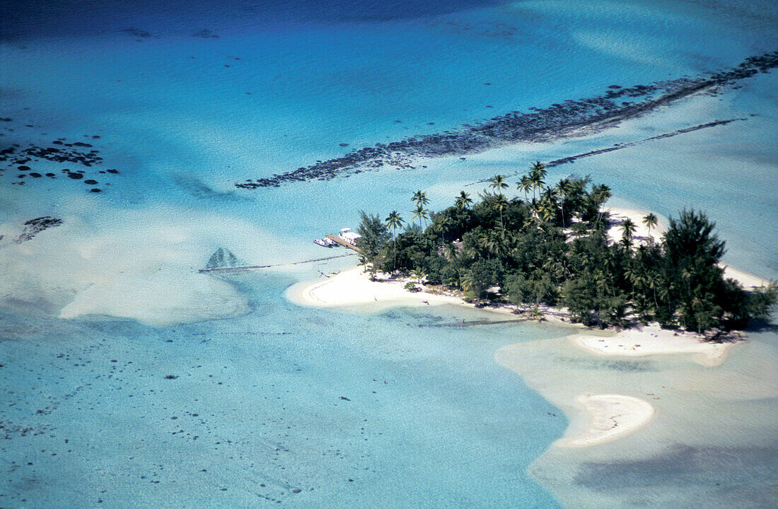 Aerial of Motu Tapu islet in the lagoon. Bora Bora island, Leeward Islands. French Polynesia