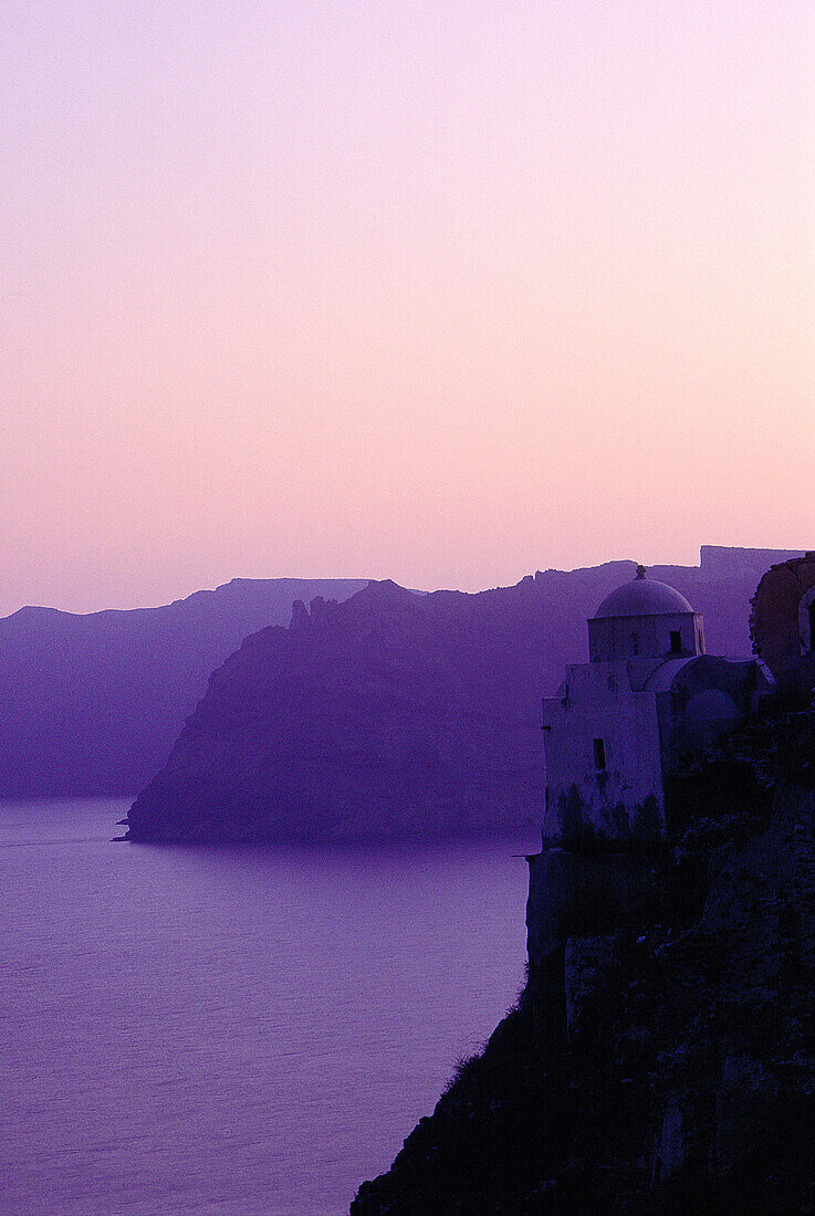 Chapel on a cliff at coastline. Santorini. Greece