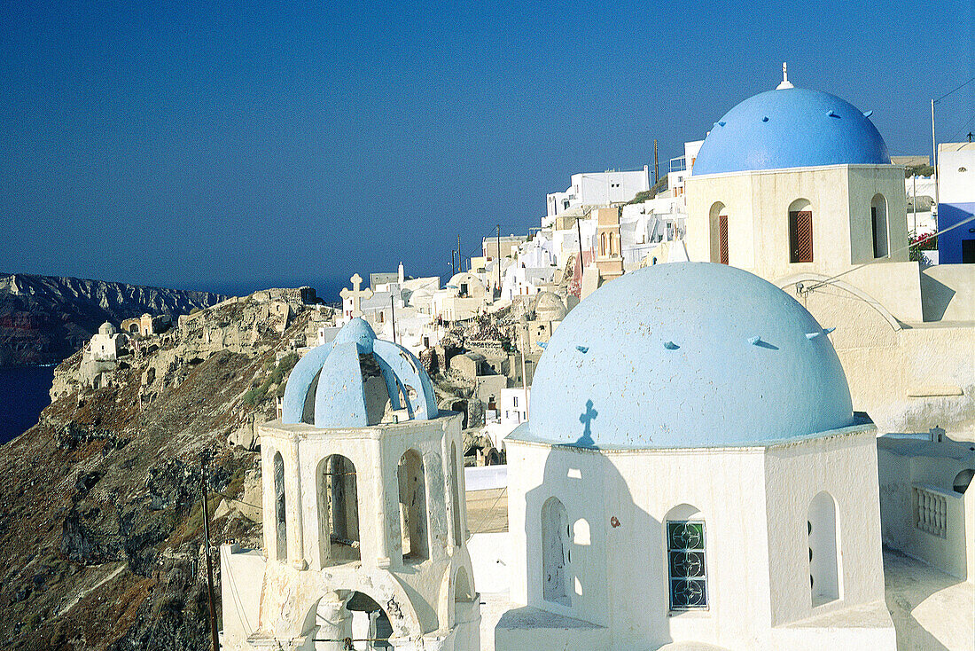 Ia village. Churches Domes and belfries painted in blue. Santorini. Greece