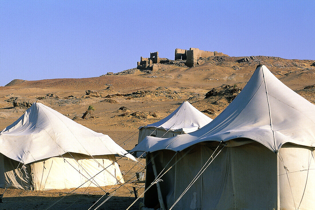 Soldiers tents near ruined Roman fortress at Kharga oasis. Libyan desert, Egypt