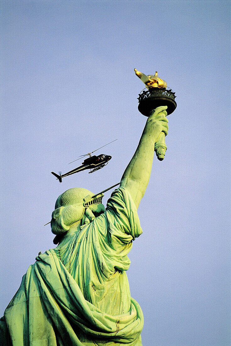 USA. NYC. Manhattan. Liberty statue and helicopter