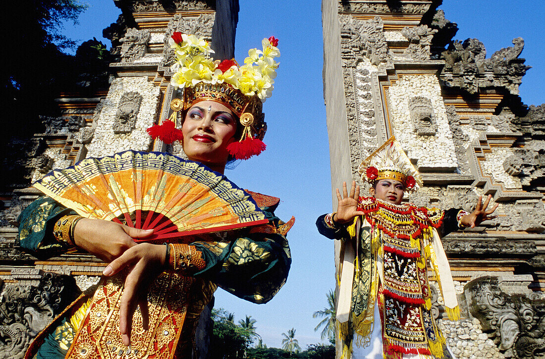 Young female LeGong dancer and Baris dancer in a temple. Bali island. Indonesia (Model released)