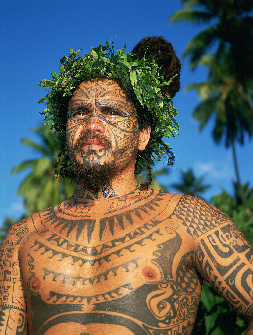 Young man tattoer and tattoed at Tiki Village, Haapiti. Moorea island. Windward islands. French Polynesia