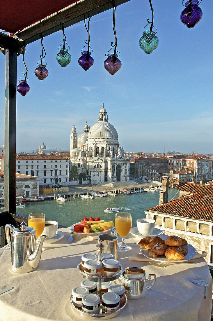 Breakfast on the Grand Hotel Bauer Roof terrace. Ancient palazzeto overlooking Grand Canal and La Salute church. City of Venice. Venetia. Italy