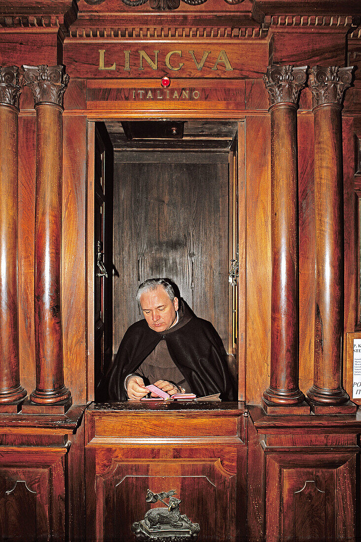 Priest in confessionnal waiting for sinners, San Giovanni in Laterano. Rome, Italy