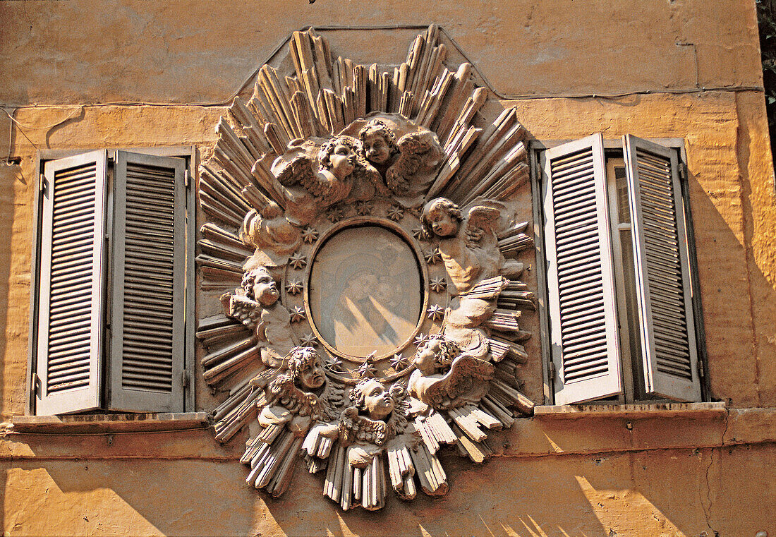 Round window, baroque architectural detail. Rome, Italy