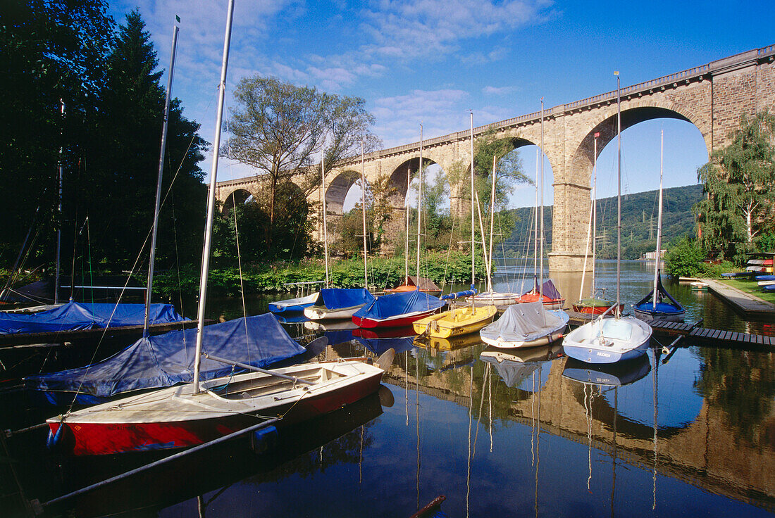 Railroad viaduct over harbor for sailboats at river Ruhr, Herdecke, Northrhine-Westphalia, Germany