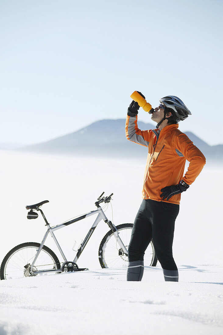 Mountain biker drinking from a bottle, Styria, Austria