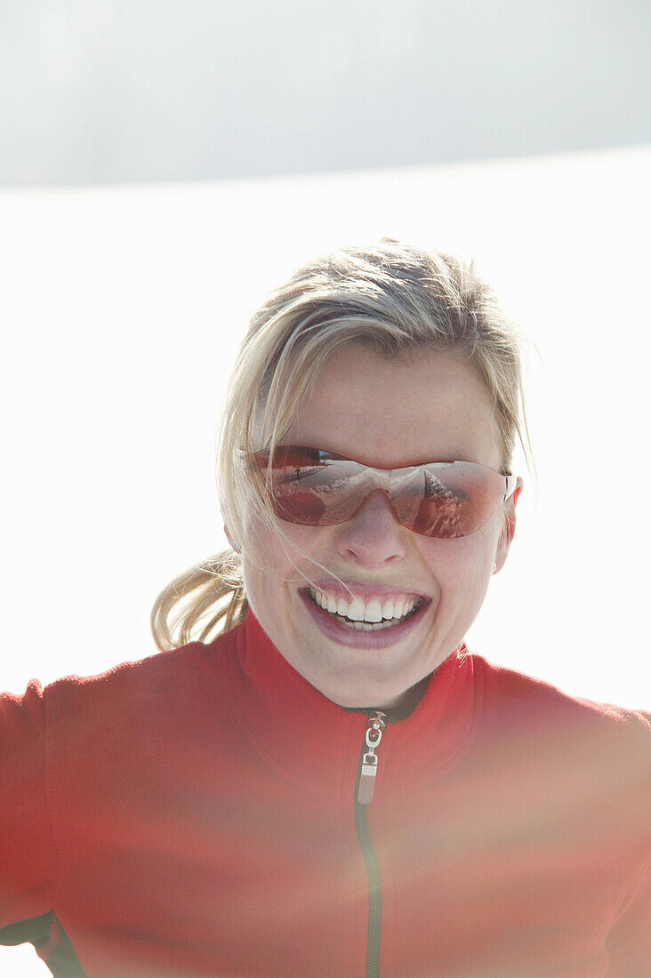 Woman wearing sunglasses smiling at camera, Styria, Austria