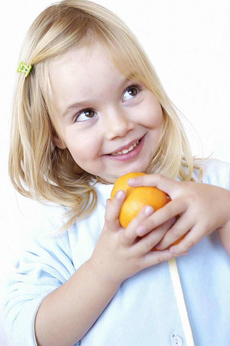 casian, Caucasians, Child, Childhood, Children, Citrus fruits, Color, Colour, Contemporary, Facial expression, Facial expressions, Fair-haired, Female, Food, Fruit, Fruits, Girl, Girls, Grin, Grinning