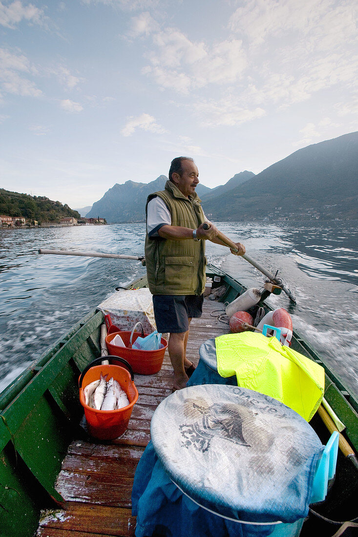 Fisherman at work on the lake. Iseo lake. Lombardia. Italy.