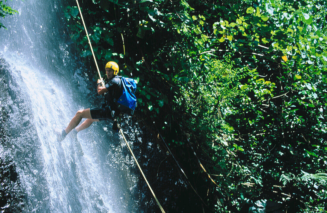 Canyoning in a waterfall, Tahiti