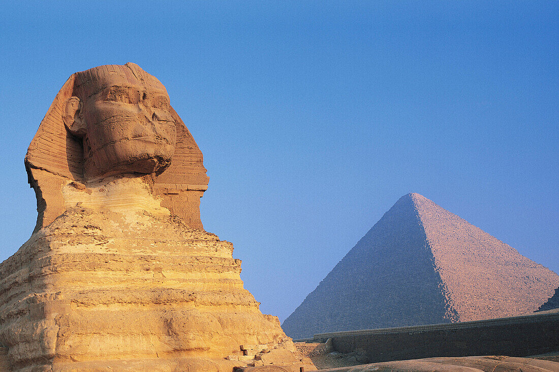 The Sphinx and Keops Pyramid at sunrise. Gizeh. Egypt