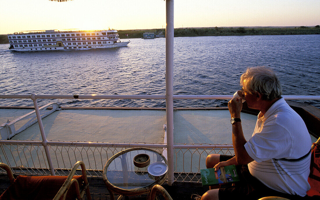 Passenger having a drink on the deck during the end of the day at steamboat built in 1890. Egypt