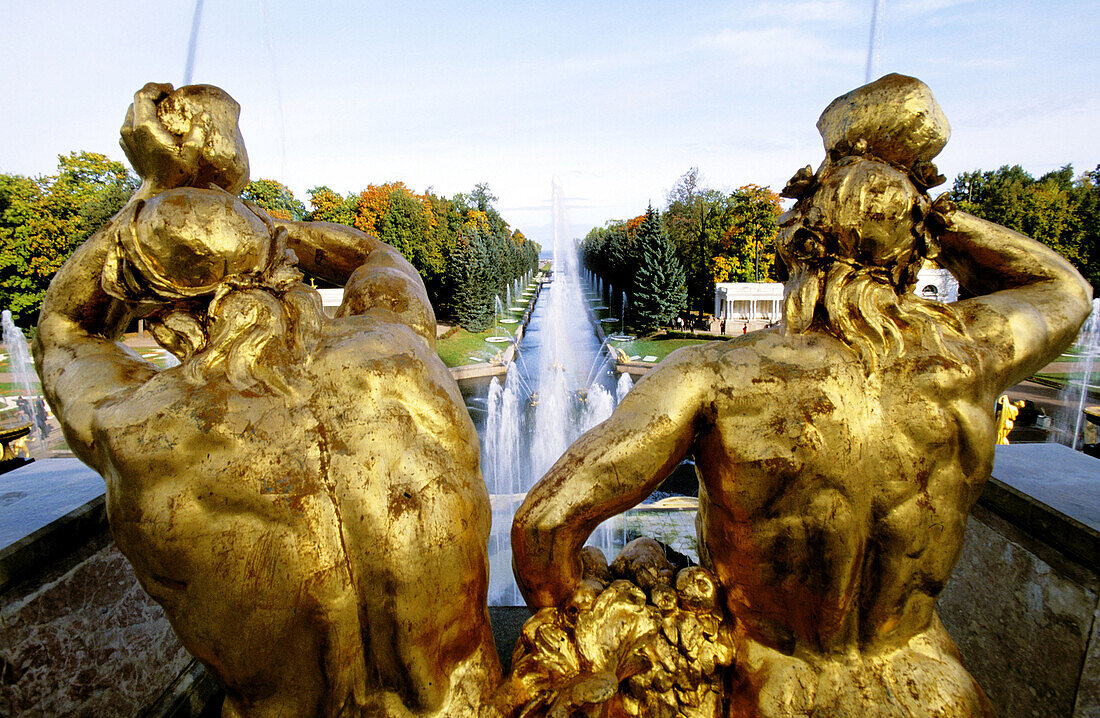 Golden statues, water works and perspective on the canal to Baltic Sea at Peterhof Park. Petrodvorets, St. Petersburg. Russia