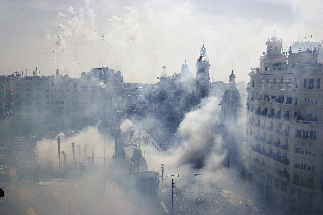 Smoke covers City Hall square during Mascletà fire works, Fallas festival. Valencia. Spain
