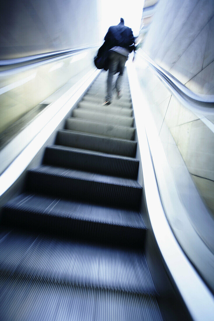  Adult, Adults, Ascending, Back view, Blurred, Climb, Climbing, Color, Colour, Contemporary, Daytime, Escalator, Escalators, Exterior, Full-body, Full-length, Human, Low angle view, Male, Man, Men, Men only, Motion, Movement, Moving, One, One person, Outd