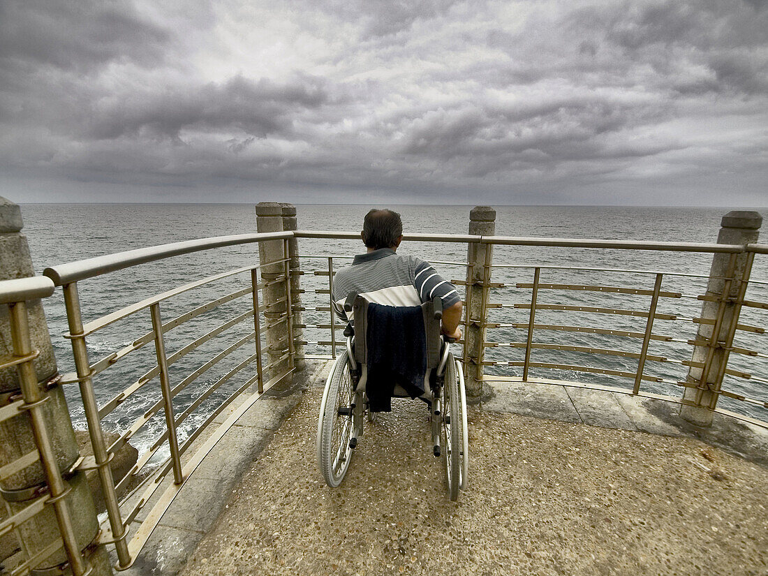  Adult, Adults, Anonymous, Back view, Beach, Beaches, Cloudy, Coast, Coastal, Color, Colour, Contemporary, Daytime, Disability, Disabled, Exterior, Fence, Fences, Full-body, Full-length, Future, Handicap, Handicapped, Horizon, Horizons, Human, Look, Looki