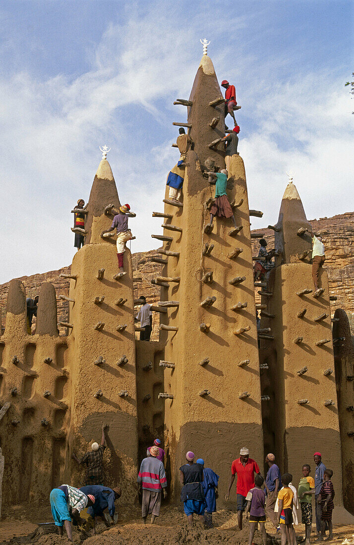 Re-plastering mud mosque, Kani Komboli. Dogon Country, Mali