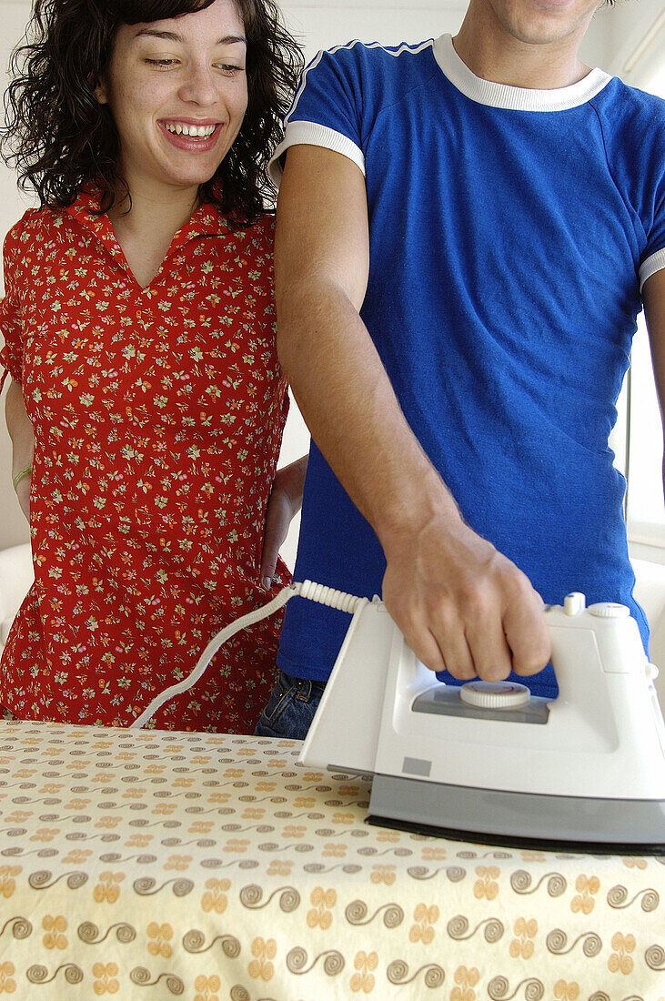 Boy ironing doing housework