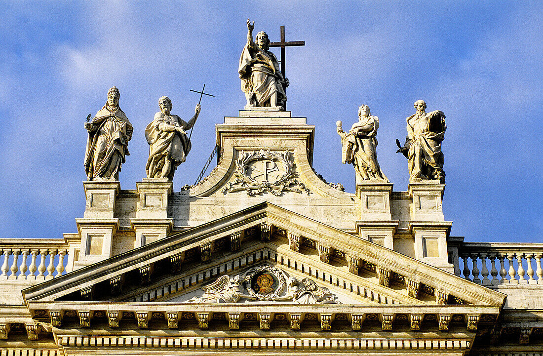 Detail of statues and pediment that top the main facade (built 1732), St. John Lateran basilica. Rome. Italy