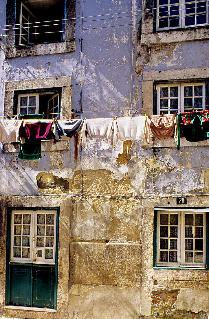 Drying laundry at a window. Lisbon. Portugal