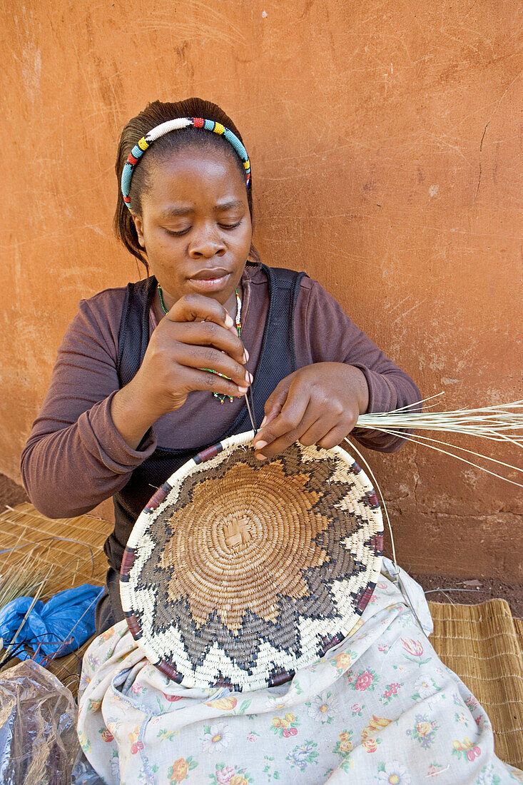 Mr Alfred village chief daughter at work with vannery. Traditional zulu craft center of Thembalethu. Kwazulu-Natal province. South Africa