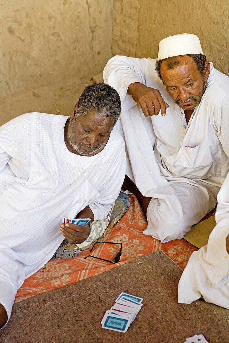 Men playing cards in the village of Dalgo. Upper Nubia, ash-Shamaliyah state, Sudan