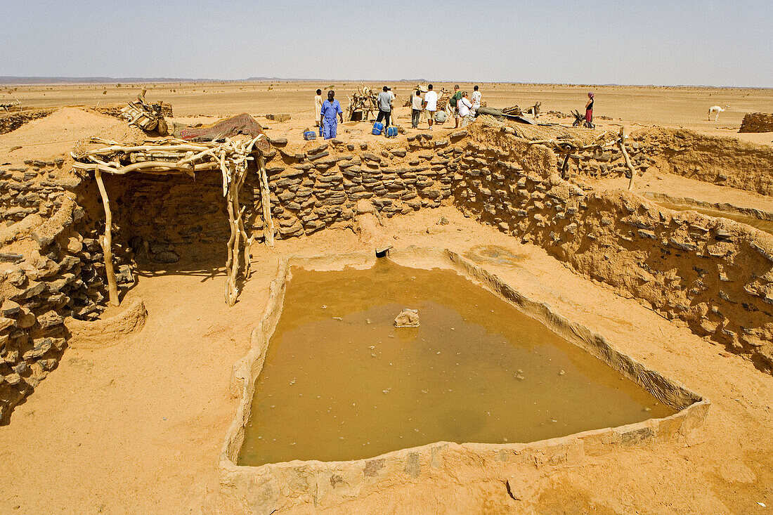 Bedouins at well on the trail from Karima to Atbarah through the Bayyudah Desert. Upper Nubia, ash-Shamaliyah state, Sudan