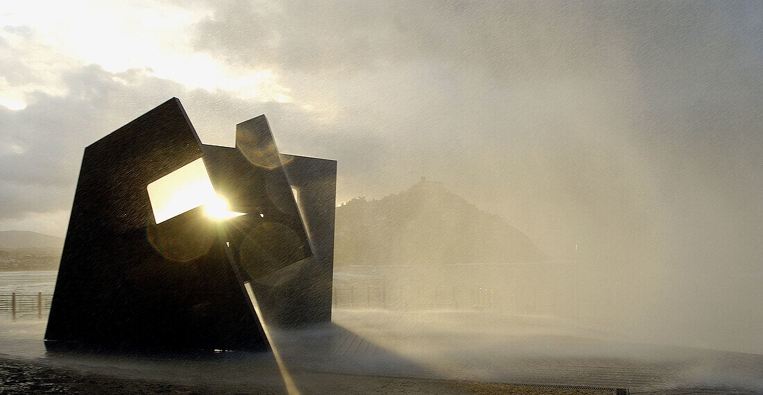 Sculpture by Jorge Oteiza and waves at Paseo Nuevo promenade. San Sebastián. Euskadi. Spain